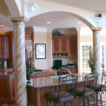 Kitchen with double island, columns and arches - Anthony Thomas Builders